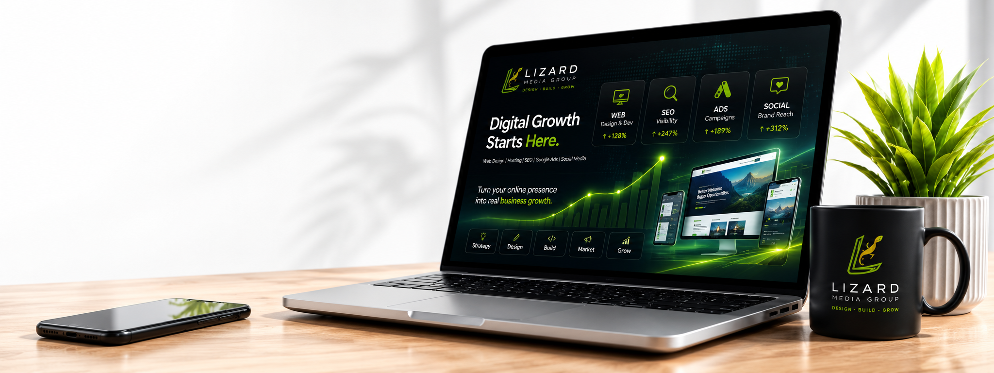Lizard Media workspace with a laptop displaying a conceptual digital performance dashboard, smartphone, plant and branded mug